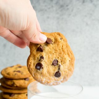 Dipping a chocolate chip cookie into a glass of milk