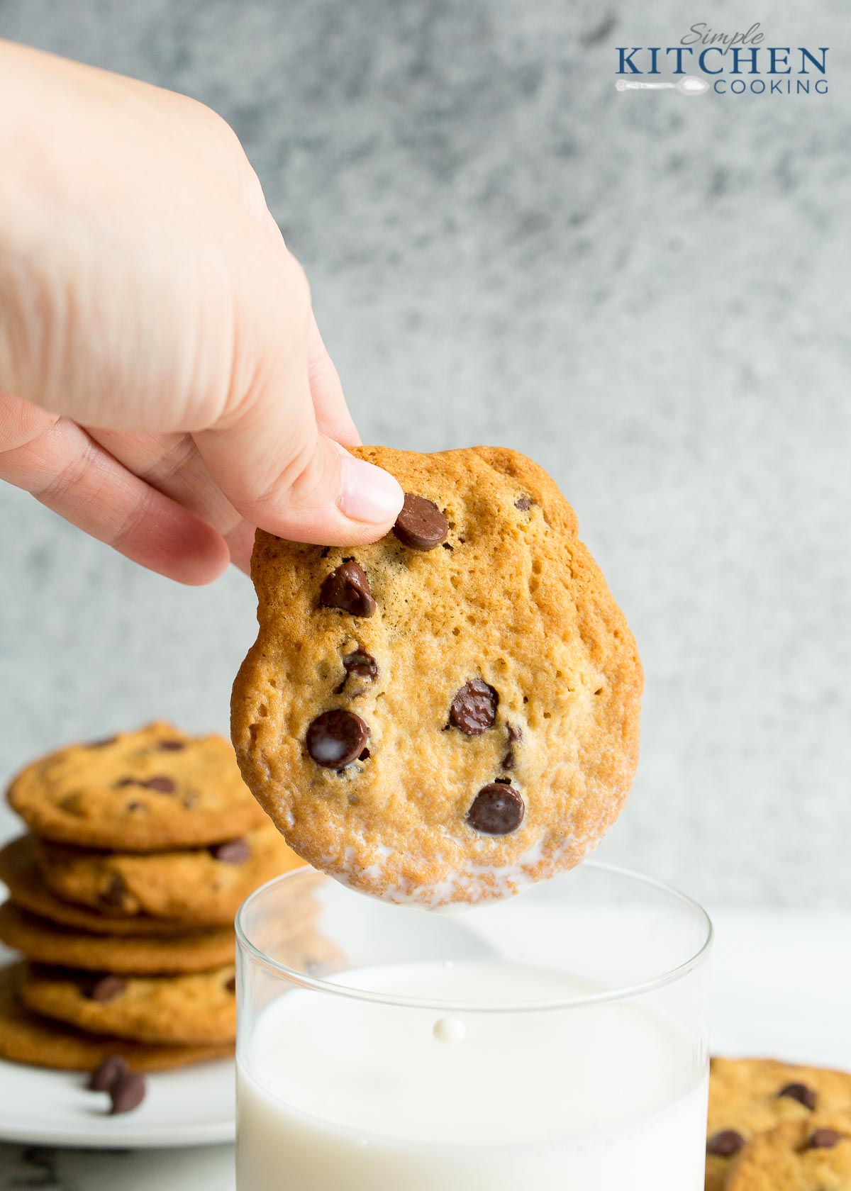 Dipping a chocolate chip cookie into a glass of milk